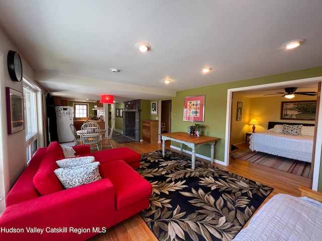 living room featuring hardwood / wood-style flooring and ceiling fan