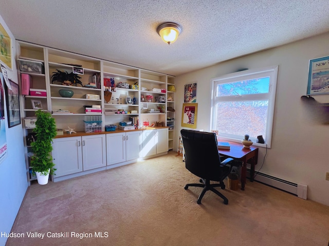 office area with a textured ceiling, light colored carpet, and baseboard heating