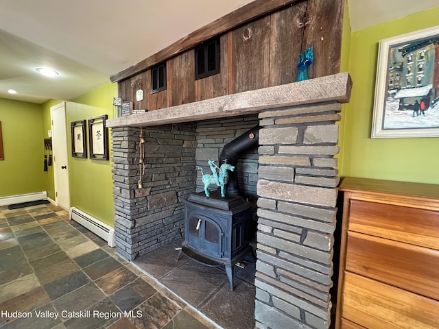 interior details featuring a wood stove and a baseboard heating unit