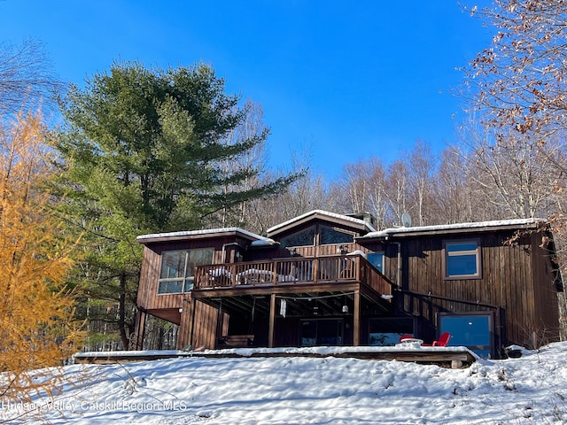 view of front of property featuring a garage and a deck