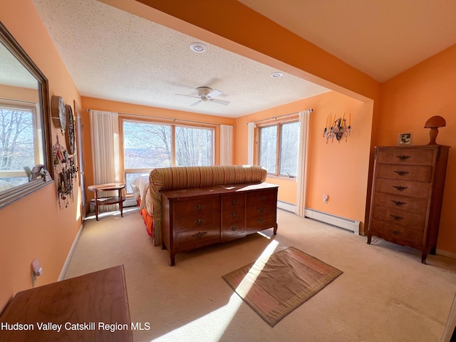 bedroom with light colored carpet, baseboard heating, and multiple windows