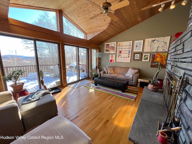 living room featuring hardwood / wood-style floors, high vaulted ceiling, ceiling fan, and wood ceiling