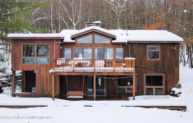 snow covered property featuring a deck