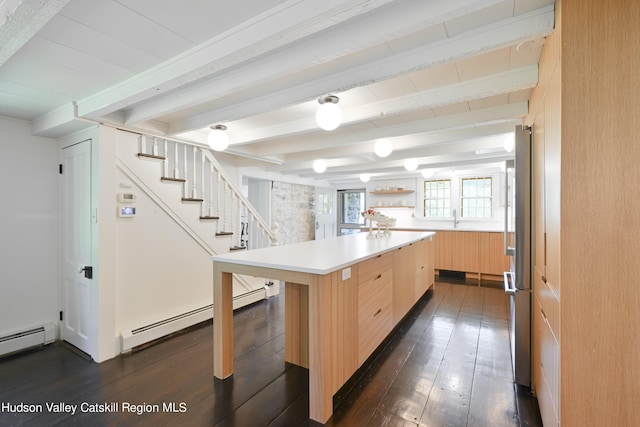 kitchen with a kitchen breakfast bar, dark wood-type flooring, light brown cabinets, beam ceiling, and a kitchen island