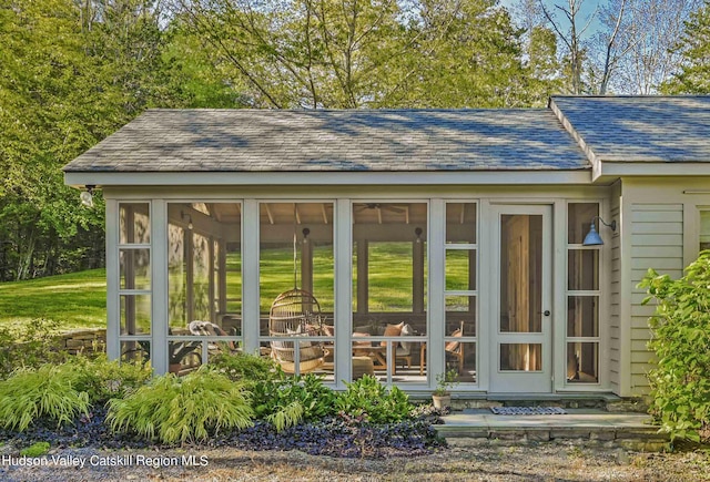 view of outdoor structure with a sunroom