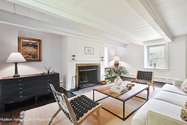 living room with beam ceiling, hardwood / wood-style flooring, and a baseboard heating unit