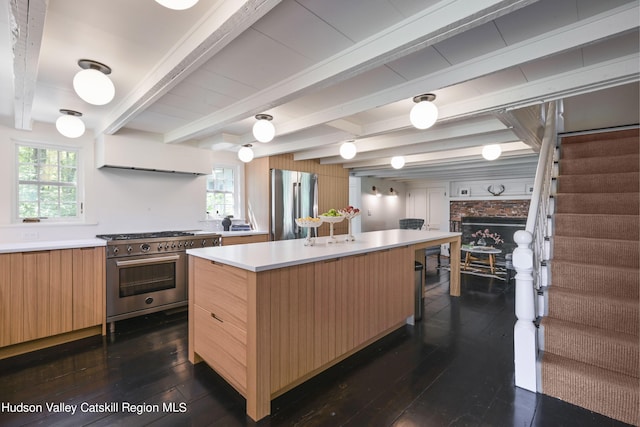 kitchen with beam ceiling, a center island, stainless steel appliances, and dark hardwood / wood-style floors