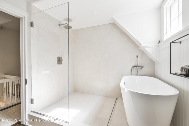 bathroom featuring separate shower and tub and tile patterned flooring