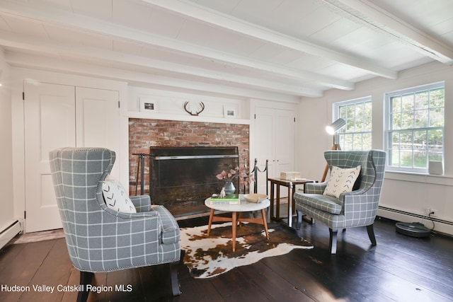 sitting room featuring a fireplace, beamed ceiling, and dark hardwood / wood-style floors