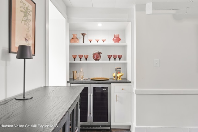 bar featuring an AC wall unit and beverage cooler