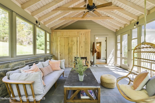 sunroom featuring vaulted ceiling with beams, ceiling fan, and wood ceiling