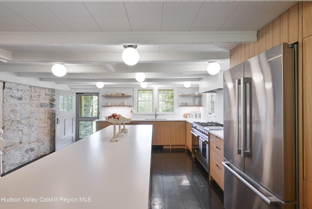 kitchen featuring plenty of natural light, beam ceiling, high quality appliances, and dark wood-type flooring