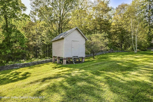 view of outbuilding featuring a lawn