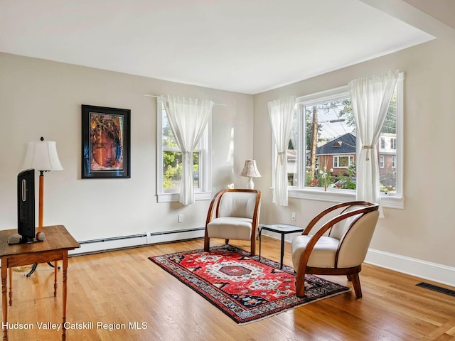 90 Emerson St, Kingston, NY 12401 - sitting room featuring healthy amount of natural light, wood finished floors, and baseboard heating
