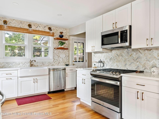 90 Emerson St, Kingston, NY 12401 - kitchen featuring appliances with stainless steel finishes, light countertops, and white cabinets