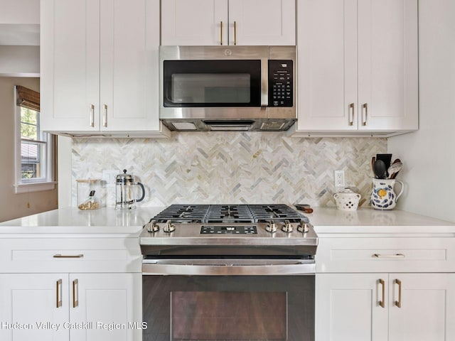 90 Emerson St, Kingston, NY 12401 - kitchen featuring appliances with stainless steel finishes, light countertops, tasteful backsplash, and white cabinets