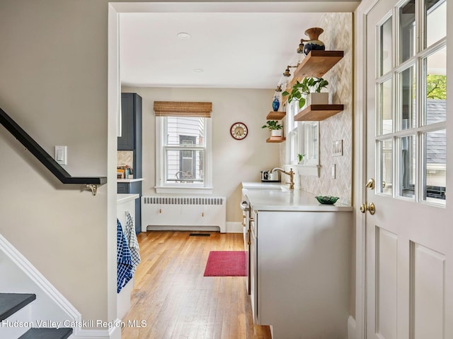 90 Emerson St, Kingston, NY 12401 - kitchen featuring open shelves, radiator, light wood-style floors, and light countertops