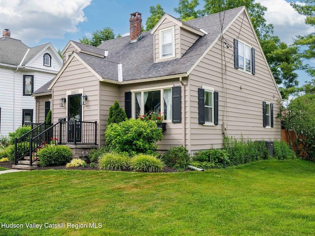 90 Emerson St, Kingston, NY 12401 - cape cod-style house with roof with shingles, a front yard, and a chimney