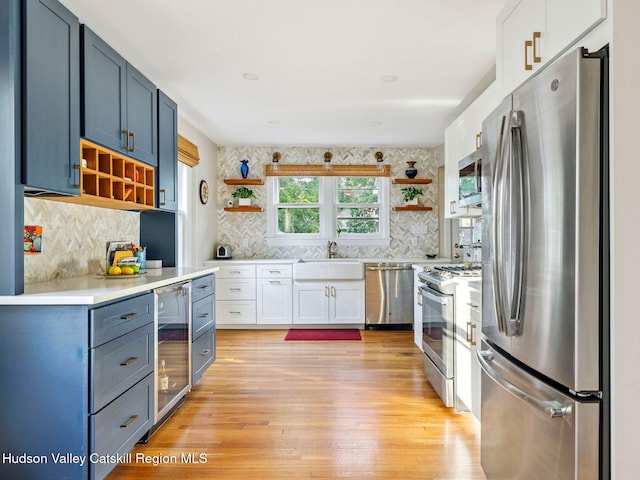 90 Emerson St, Kingston, NY 12401 - kitchen with open shelves, appliances with stainless steel finishes, light wood-style flooring, and light countertops