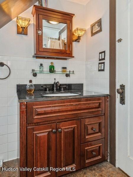 bathroom with decorative backsplash and vanity