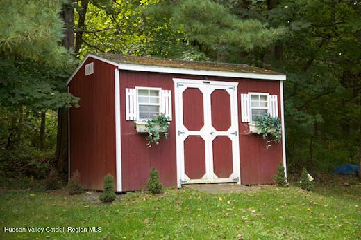 view of outbuilding featuring a yard