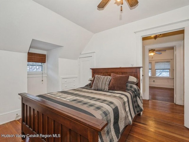 bedroom featuring dark wood-type flooring, ceiling fan, and vaulted ceiling