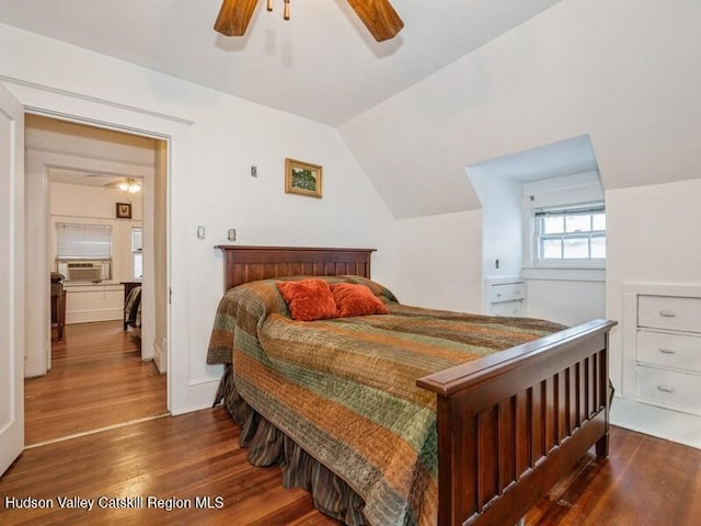 bedroom featuring ceiling fan, cooling unit, dark hardwood / wood-style flooring, and vaulted ceiling