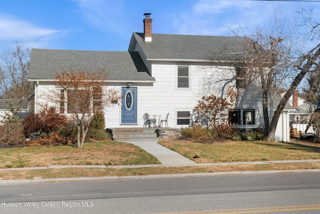 tri-level home with a front yard