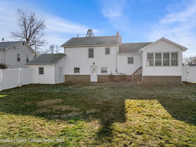 back of property featuring a lawn