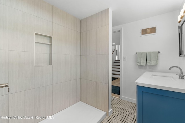 bathroom with a shower and vanity