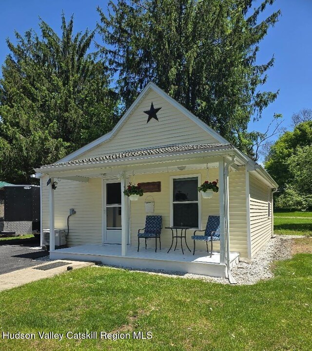 280 Continental Rd, Napanoch, NY 12489 - rear view of property featuring a porch, a lawn, and central air condition unit