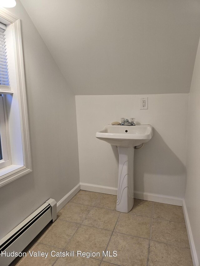 280 Continental Rd, Napanoch, NY 12489 - bathroom featuring baseboard heating, vaulted ceiling, tile patterned floors, baseboards, and a sink