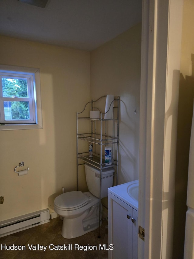 280 Continental Rd, Napanoch, NY 12489 - half bathroom with a baseboard radiator, toilet, vanity, and tile patterned floors