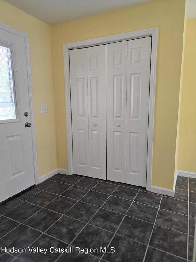 280 Continental Rd, Napanoch, NY 12489 - entrance foyer featuring dark tile patterned floors and baseboards