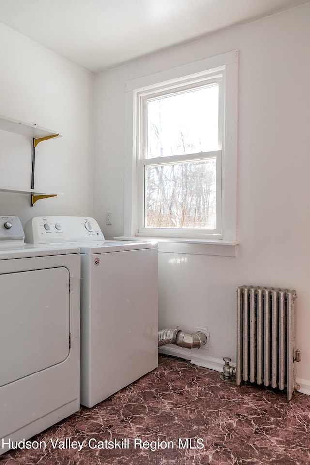 laundry area featuring washer and dryer and radiator