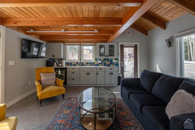  - carpeted living room with wood ceiling, beverage cooler, beamed ceiling, and baseboards
