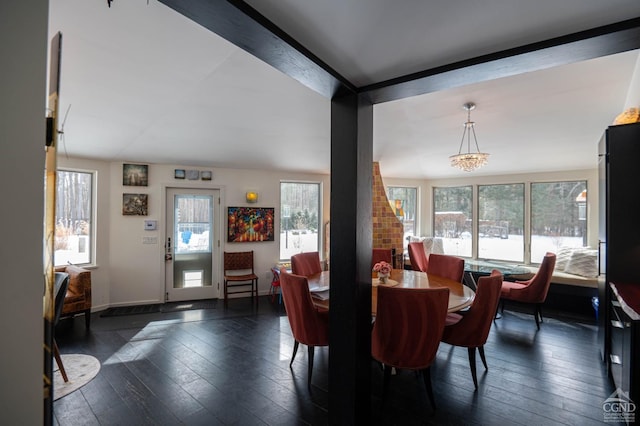  - dining area with healthy amount of natural light and dark wood-type flooring
