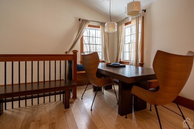  - dining room with wood finished floors and lofted ceiling