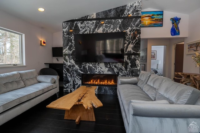  - living area featuring vaulted ceiling, a fireplace, recessed lighting, and wood finished floors
