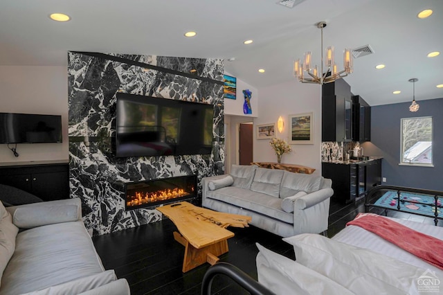  - living area with a chandelier, vaulted ceiling, a high end fireplace, recessed lighting, and baseboards