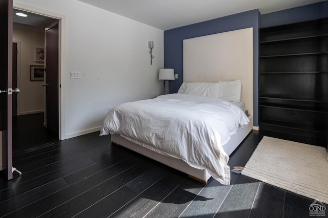  - bedroom featuring wood finished floors and baseboards