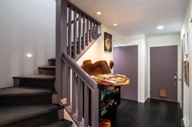 - stairway with wood finished floors, recessed lighting, and baseboards