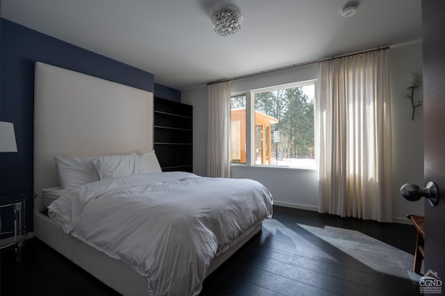  - bedroom with baseboards and dark wood-type flooring