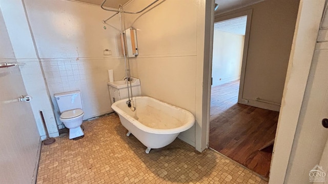 801 Columbia St, Hudson, NY 12534 - bathroom with a freestanding bath, toilet, a shower, and tile walls