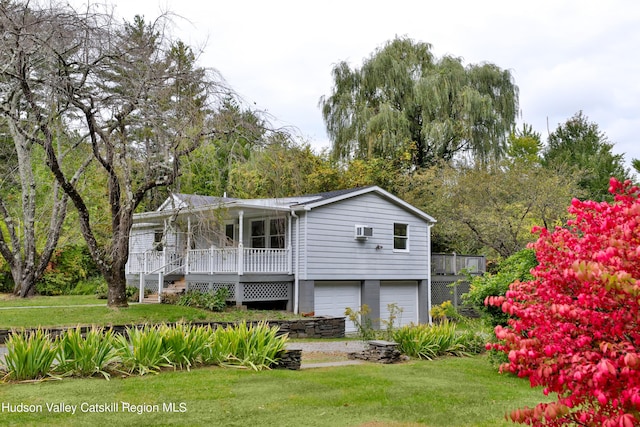 view of front facade featuring a front yard, a porch, and a garage