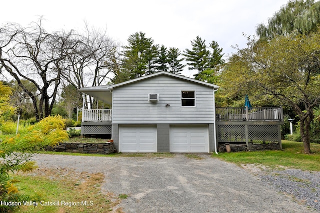 view of side of property featuring a garage and a wooden deck