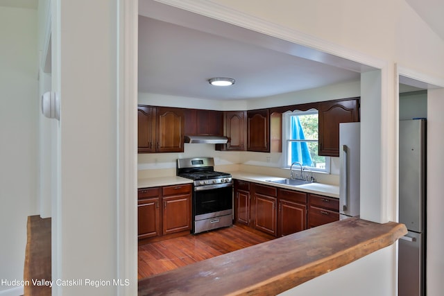 kitchen with dark hardwood / wood-style flooring, sink, and appliances with stainless steel finishes