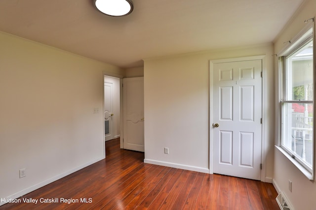 unfurnished bedroom featuring dark wood-type flooring