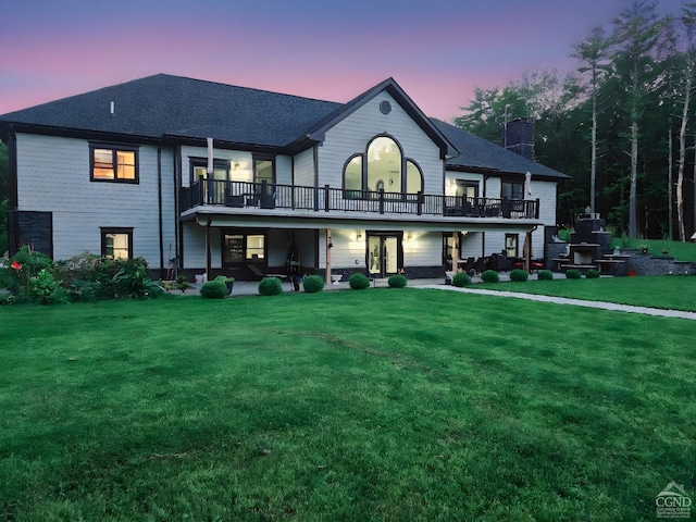 174 Webber Rd, Coxsackie, NY 12058 - back of house at dusk featuring french doors, a lawn, a patio, a balcony, and a chimney