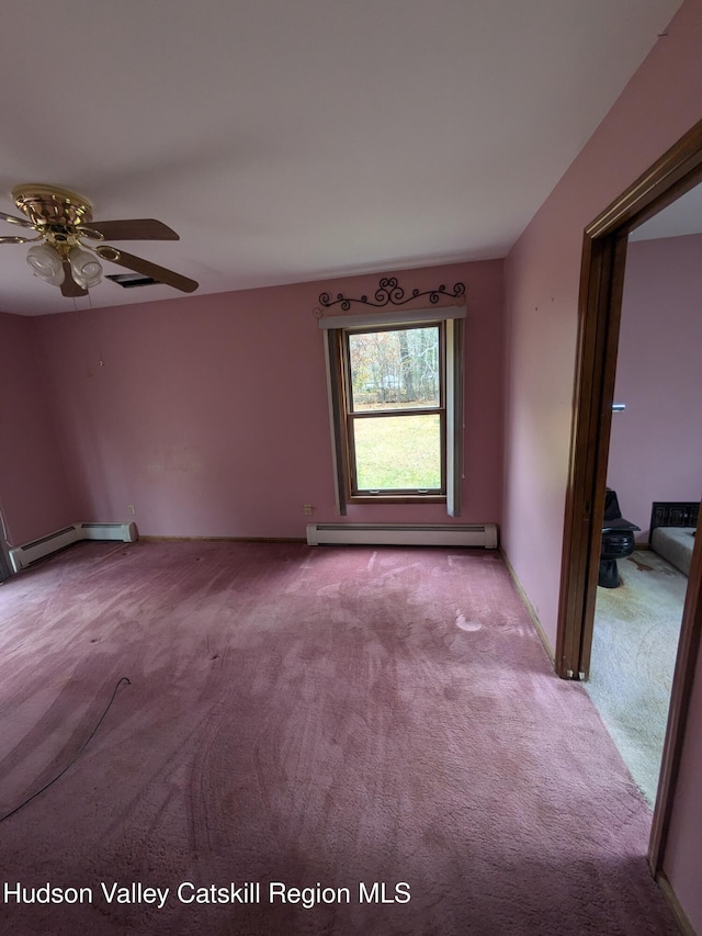 carpeted spare room with baseboard heating and ceiling fan